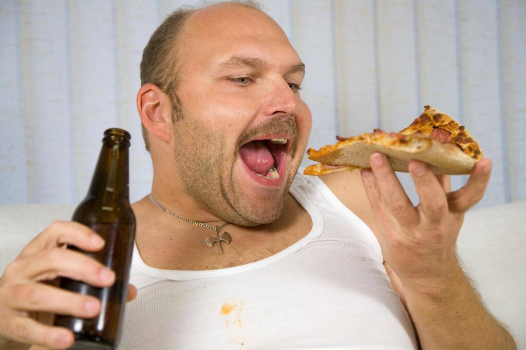 Overweight mature man with pizza