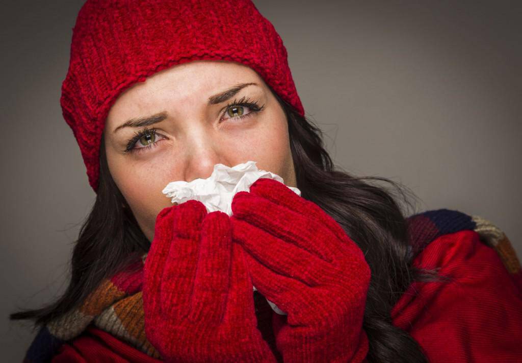 woman-with-cold-blowing-nose