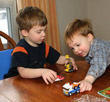 boys play with lego toys