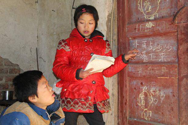 Ma-Jingjing-teaches-her-brother-Ma-Yuedong-to-read-and-write 1