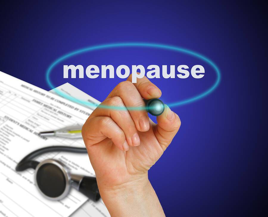 writing word MENOPAUSE with marker on gradient background