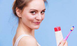 bigstock-Woman-Holds-Toothbrush-And-Pas-150835244
