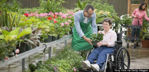 Florist helping customer seated in wheelchair