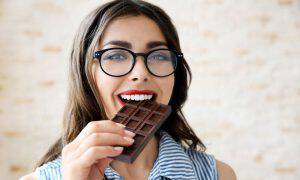 bigstock-Beautiful-girl-eating-chocolat-147569948