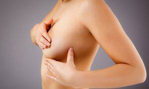 bigstock-Woman-examining-breast-38553241