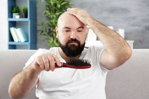 bigstock Bald adult man with hair brush 175683973