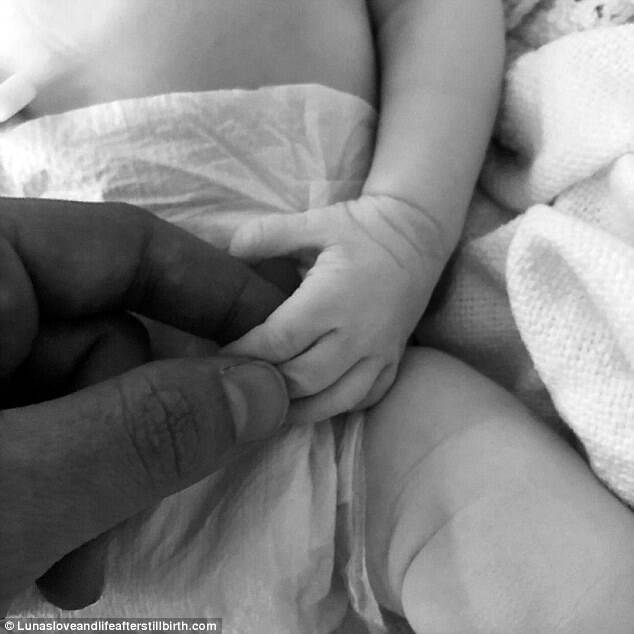 Ryan holding Luna's tiny hand.Â  She said her partner was a 'broken man' when they were told their baby had diedÂ 