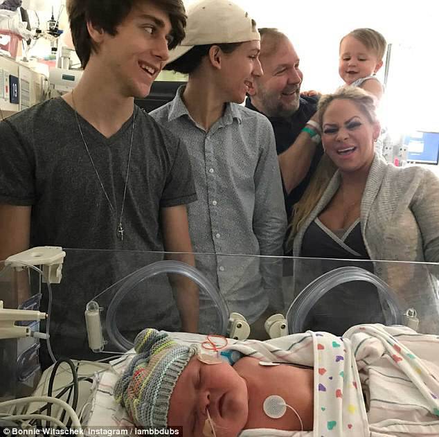 Bonnie and Mark are pictured with the couple's three sons in the hospital with Kitty