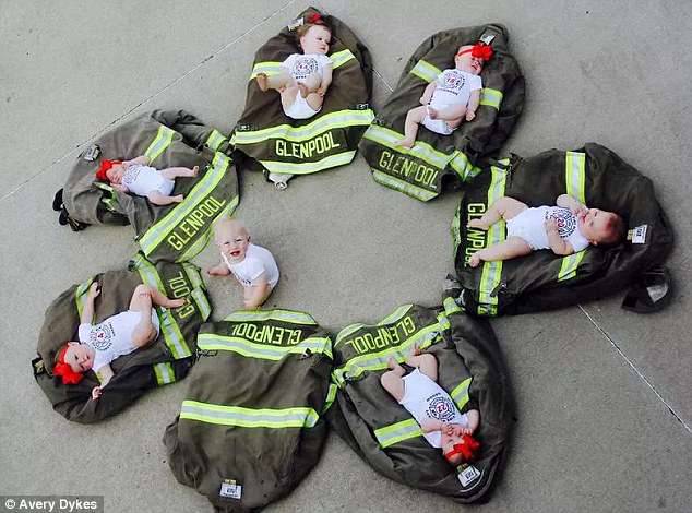 Adorable: Avery Dykes said: 'The babies are laying on their dads bunker coats. It was difficult to get the photo taken with seven babies but we are thrilled with how the pictures turned out'