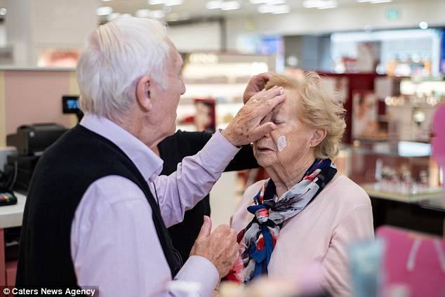 Mr Monahan gently applies a cream to his wife's face before starting the makeover