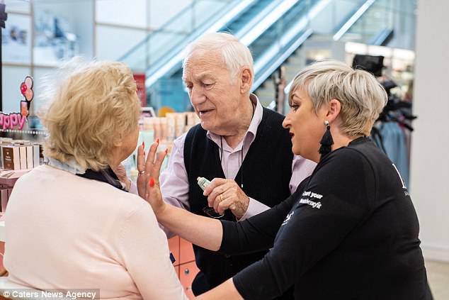 Make-up artist Ms O'Driscoll shows Mr Monahan how to dab a cream onto his wife's face