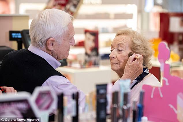 Mr Monahan applies colour onto his wife's cheeks during one recent make-up session