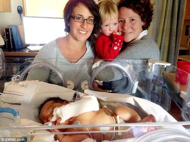 At around 18 months old, the couple put Mae back on the transplant list. Within 30 days, they got a call from Boston ChildrenÂ¿s Hospital that they found a match. Pictured: Mae with Koslow and Vogel and her older sister Rosie