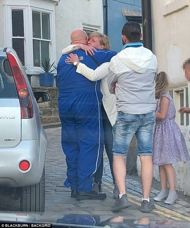 Locals looked visibly upset as they comforted one another following the tragic incident with one Twitter user describing the atmosphere in the village as being 'solemn'