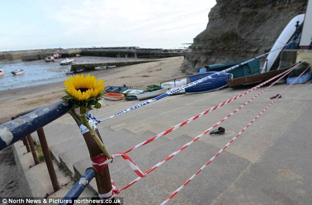 A single sunflower has been left at the scene of the girl's death. Rocks came tumbling to the ground yesterday as the girl played underneath themÂ 