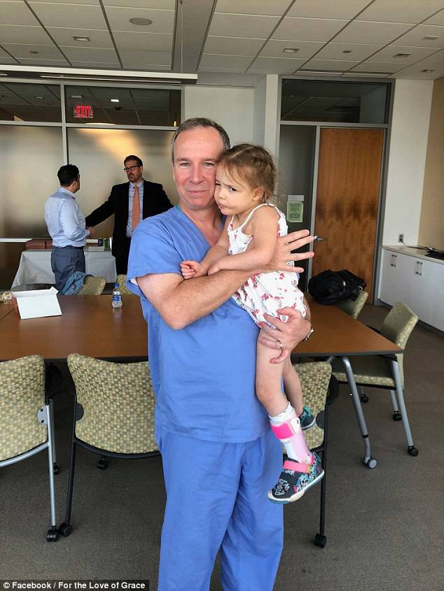 Gianna (pictured with one of her doctors) was given just weeks to live when doctors discovered she had a massive tumor on her brain stemÂ 