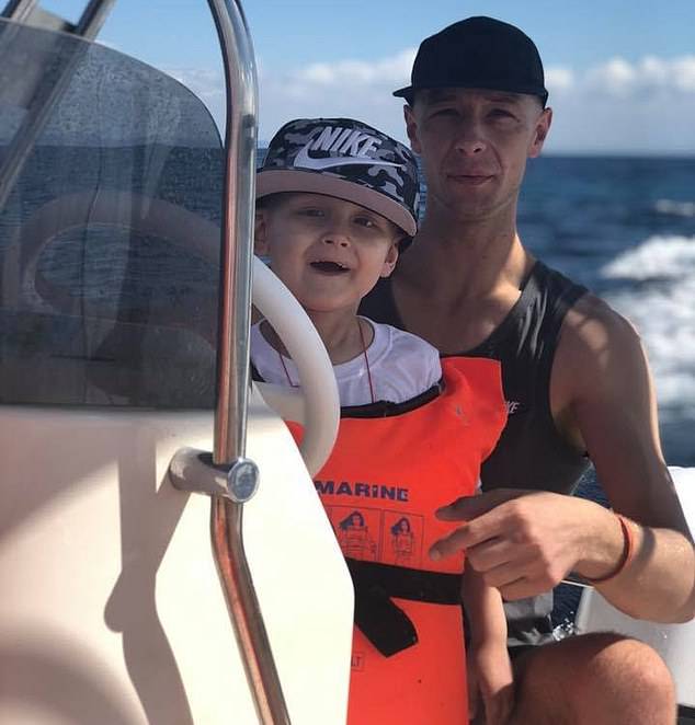 Charlie's father Ben is pictured with his son on a boat on holiday before his condition deterioratedÃÂ 