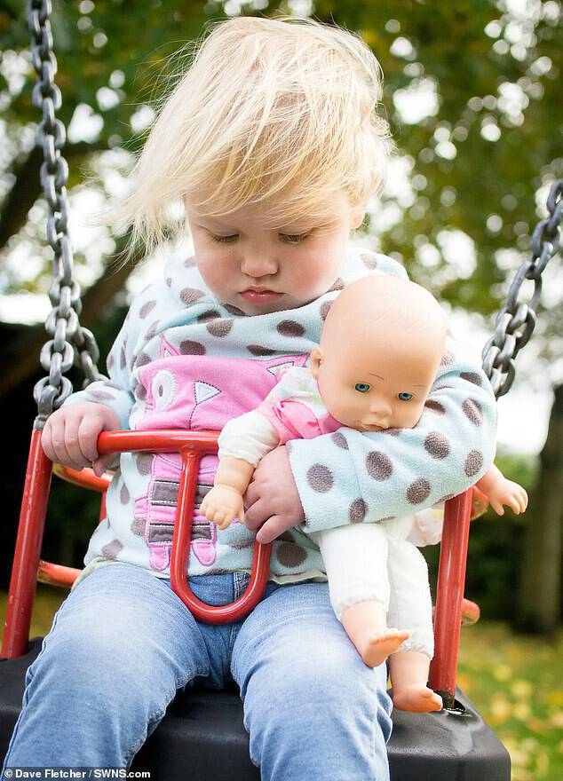 Izzy was captured by her father Dave Fletcher, 39, dosing on a playground swing when she was just 23 months old