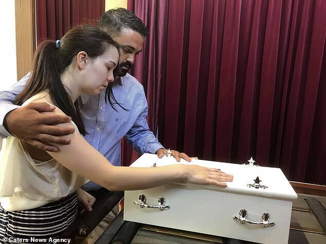Two weeks after her birth, the couple dressed Jessica for the final time before her cremation