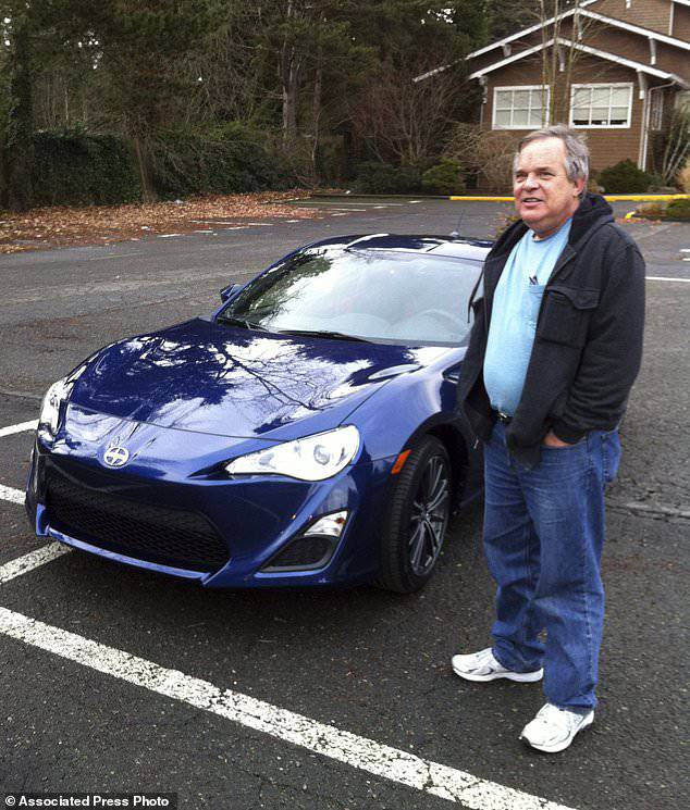 Alan Naiman poses with his new car, a Scion FR-S, an unusual extravagance for him in 2013, the same year developmentally disabled brother died