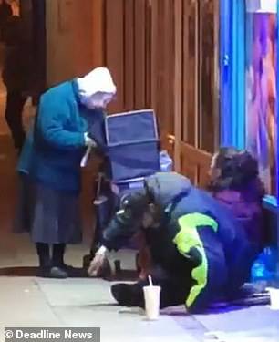 The clip shows Diana, 72, giving soup to two homeless people in Southsea, Portsmouth, as they sit on a pavement in three degree weather